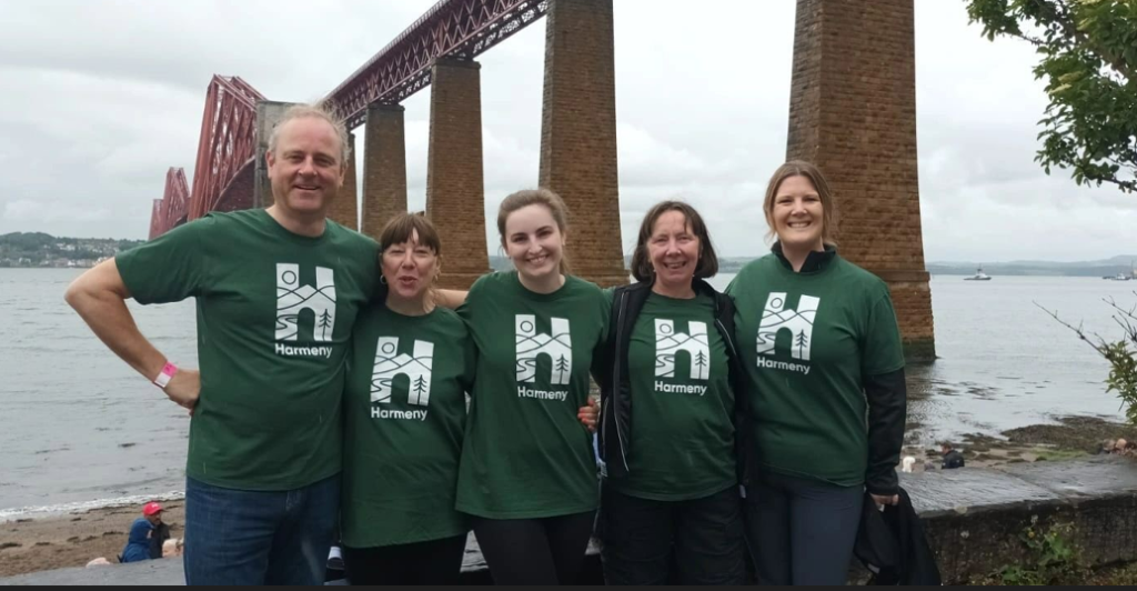 Team from RBC Brewin Dolphin standing in front of Forth Rail Bridge